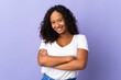 © luismolinero - Teenager cuban girl isolated on purple background keeping the arms crossed in frontal position