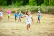 © master1305 - Kids, children running on meadow in summer's sunlight. Look happy, cheerful with sincere bright emotions. Cute caucasian boys and girls. Concept of childhood, happiness, movement, family and summer.