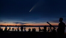 Comet Neowise And People With Cameras And Telescope Silhouetted By The Ottawa River Watching And Photographing The Comet
