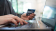 © Aris Suwanmalee - Hand Holding Credit Card And Using Laptop For Online Shopping