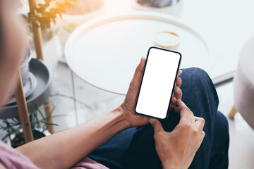 cell phone mockup image blank white screen.woman hand holding texting using mobile on desk at coffee shop.background empty space for advertise.work people contact marketing business,technology