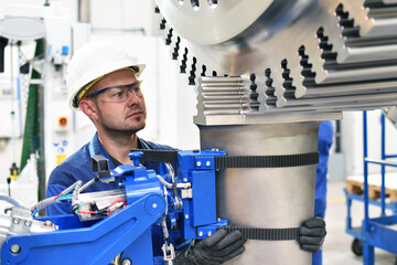 workers manufacturing steam turbines in an industrial factory