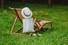 Cotton Wicker Hat And Eco Bag Near Wooden Deck Chair