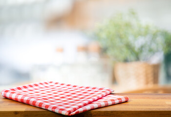 Wall Mural - Red fabric,cloth on wood table top on blur kitchen counter (room)background