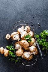 Canvas Print - Raw mushrooms champignons on black background, cooking fresh champignons.