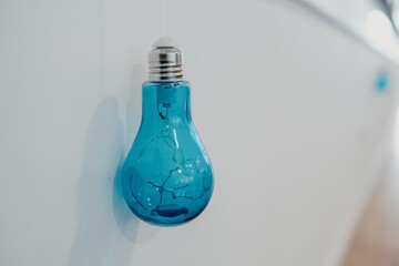 Canvas Print - Closeup shot of a blue lightbulb with a blurred background