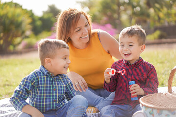 Happy young family love - Mother with twin sons in a park outdoor - Mother and childs - Focus on the boy on the right