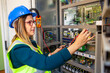 © bulentbaris - Young female maintenance engineer testing voltage with digital multimeter