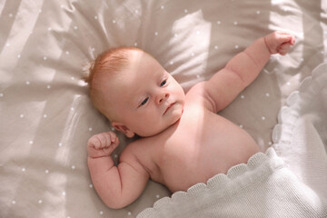 Sticker - Cute little child lying in cot, above view. Healthy baby