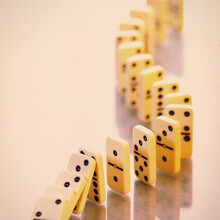 Domino Stands In A Curved Line On A Light Background.