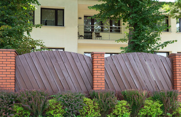 Fence made of stone and wooden boards