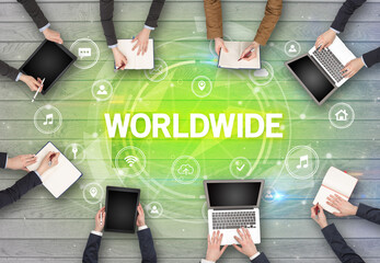 Group of people having a meeting with WORLDWIDE insciption, social networking concept