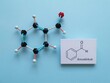 Molecular structure model and structural chemical formula of benzaldehyde. It is an aromatic aldehyde and one of the most industrially useful; a colorless liquid with a characteristic almond-like odor