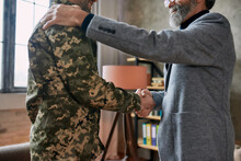Support. Cropped Shot Of Mature Psychologist Smiling, Shaking Hands With Middle Aged Military Man After Therapy Session. Soldier Suffering From Depression, Psychological Trauma. PTSD Concept