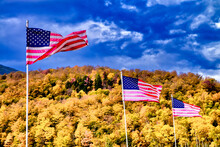 Waving American Flags In New England, Autumn Foliage Season With Orange Colors And Blue Sky