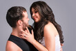 © danmorgan12 - Portrait of Sensual Flirting Caucasian Couple Posing Together. Woman Embracing Man And Touching Cheek Against Gray.