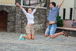 © danmorgan12 - Vacations Travel Ideas. Happy Caucasian Couple Having Fun and Jumping Together During City Traveling.