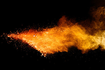 Wall Mural - freeze motion of orange color powder exploding on black background.