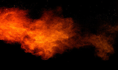 Wall Mural - Freeze motion of orange color powder exploding on black background. 