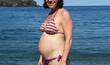 pregnant woman standing on the sea