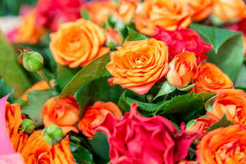 Luxurious bouquet of red and orange beautiful roses. Close-up. Top view. Holidays and celebration.