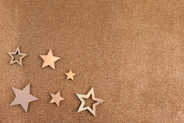 Rose gold stars and glitter on light brown background