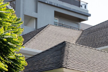 Sticker - edge of roof shingle background. dark asphalt tiles on the roof background.