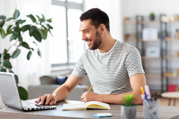 Poster - remote job, technology and people concept - young man with notebook and laptop computer working at home office