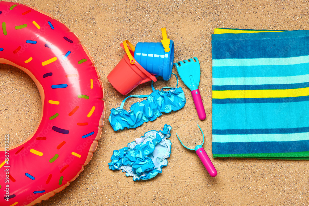 Set of beach accessories for children on sand, top view
