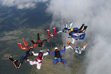 Wall Mural - Skydiving. A circle figure of skydivers is in the sky.