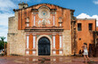 The tourist is photographing the facade of the Convento de la Orden de los Predicadores in Santo Domingo