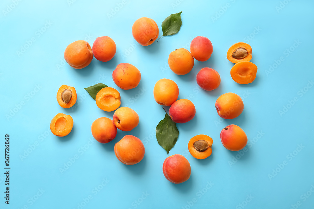 Tasty ripe apricots on color background