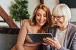 © InsideCreativeHouse - Positive senior woman and her daughter using tablet at home