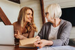 © InsideCreativeHouse - Portrait of businesswoman consulting with retired woman at home