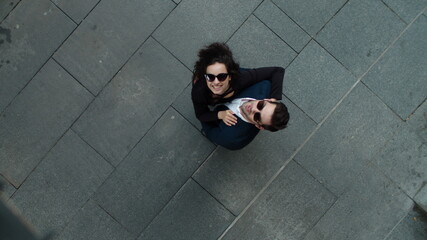 Top view couple hugging at street. Business couple smiling together outside