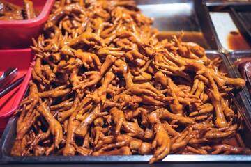 Poster - Closeup shot of a shop with chicken feet in Traditional night market in Zhubei, Taiwan