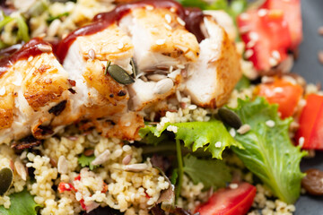 Sticker - chicken with vegetables and quinoa on dish on ceramic background