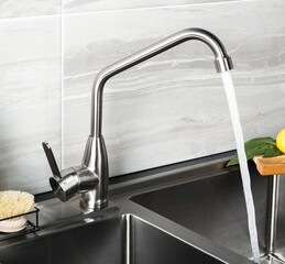 Sticker - New and  modern steel faucet in the kitchen