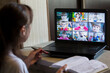© Светлана Лазаренко - Back view of teacher talking with children in a video conference. Teacher and students using laptop for online learning in video call. A group of schoolchildren studying from home.