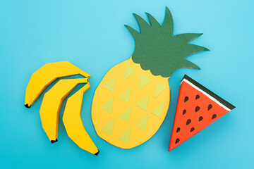 Sticker - top view of paper summer fruits on blue background