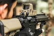 © Rattanapon - Military shooter with his precising assault rifle aiming and shooting target in the range