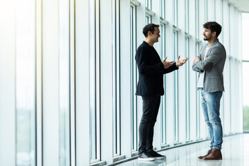 Business partners talking inside the office building