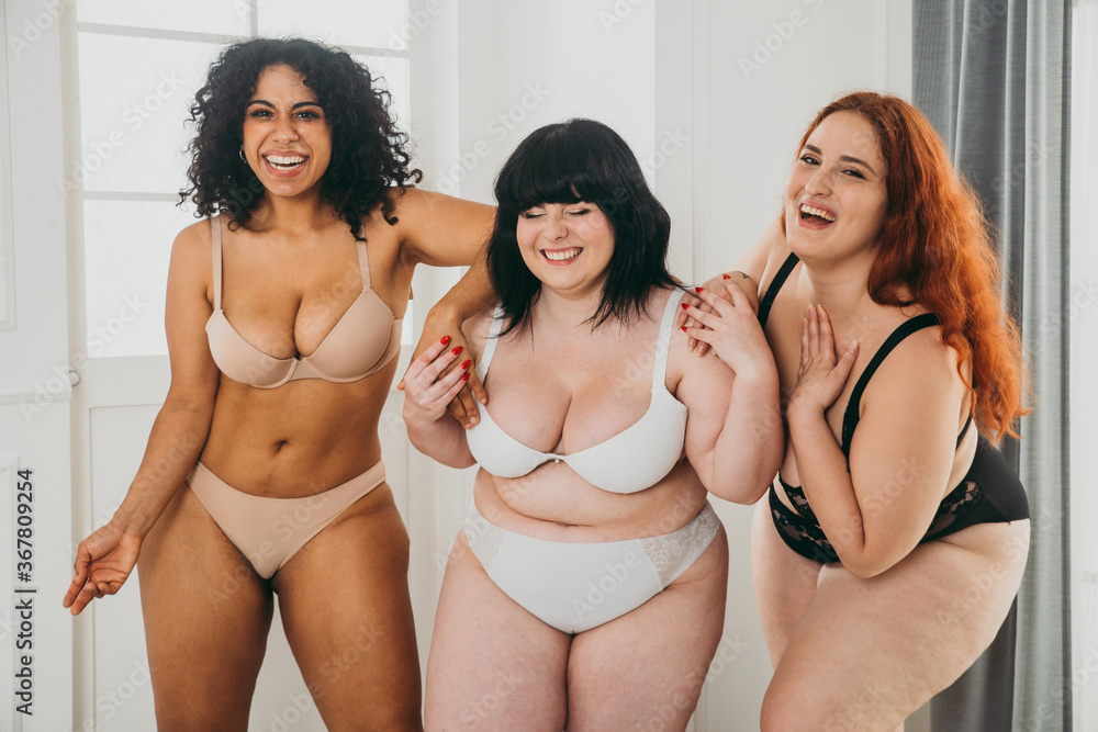 Body acceptance concept. Group of curvy girl posing in studio against society prejudice - obrazy, fototapety, plakaty 