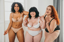 Body Acceptance Concept. Group Of Curvy Girl Posing In Studio Against Society Prejudice
