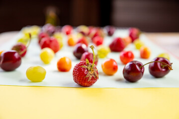 Various fresh berries isolated on pstel background,creative flat lay.Colorful fruit pattern, side view.Creative summer food concept