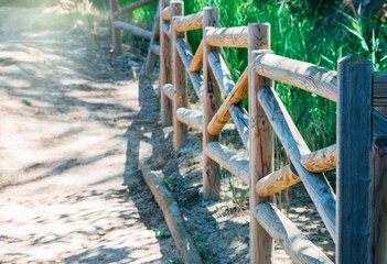 Sticker - Wooden fence in a park on background of blurred pathway