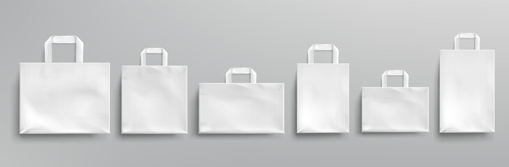 White paper eco bags different shapes. Vector realistic mockup of blank packets with handles isolated on gray background. Template for corporate design on cardboard bag for store or market