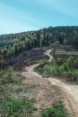 Wall Mural - car travel concept suv driving by country road leading to the mountains