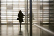 © Bill Gallery - Full length rear view of businesswoman walking in corridor at office building
