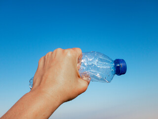  Beach plastic bottle is holding in female hand